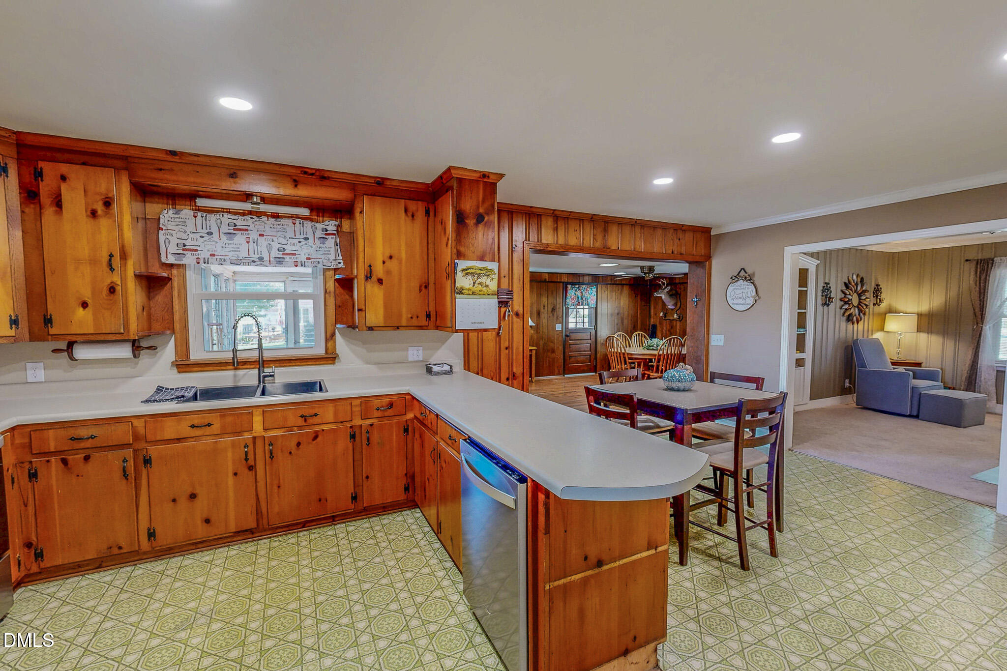 12057 Hurdle Mills Road Hurdle Mills, NC 27541 - Photo 24 of 52 a kitchen with stainless steel appliances granite countertop sink stove and wooden cabinets