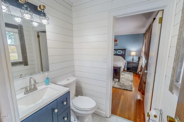 a bedroom with a bed dresser and a window