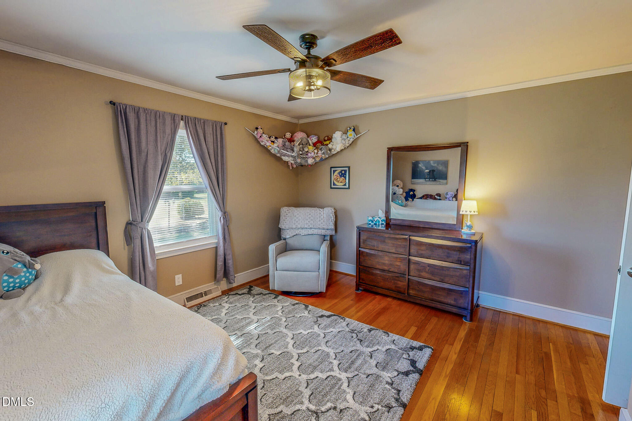 12057 Hurdle Mills Road Hurdle Mills, NC 27541 - Photo 36 of 52 a bedroom with a bed dresser and a window