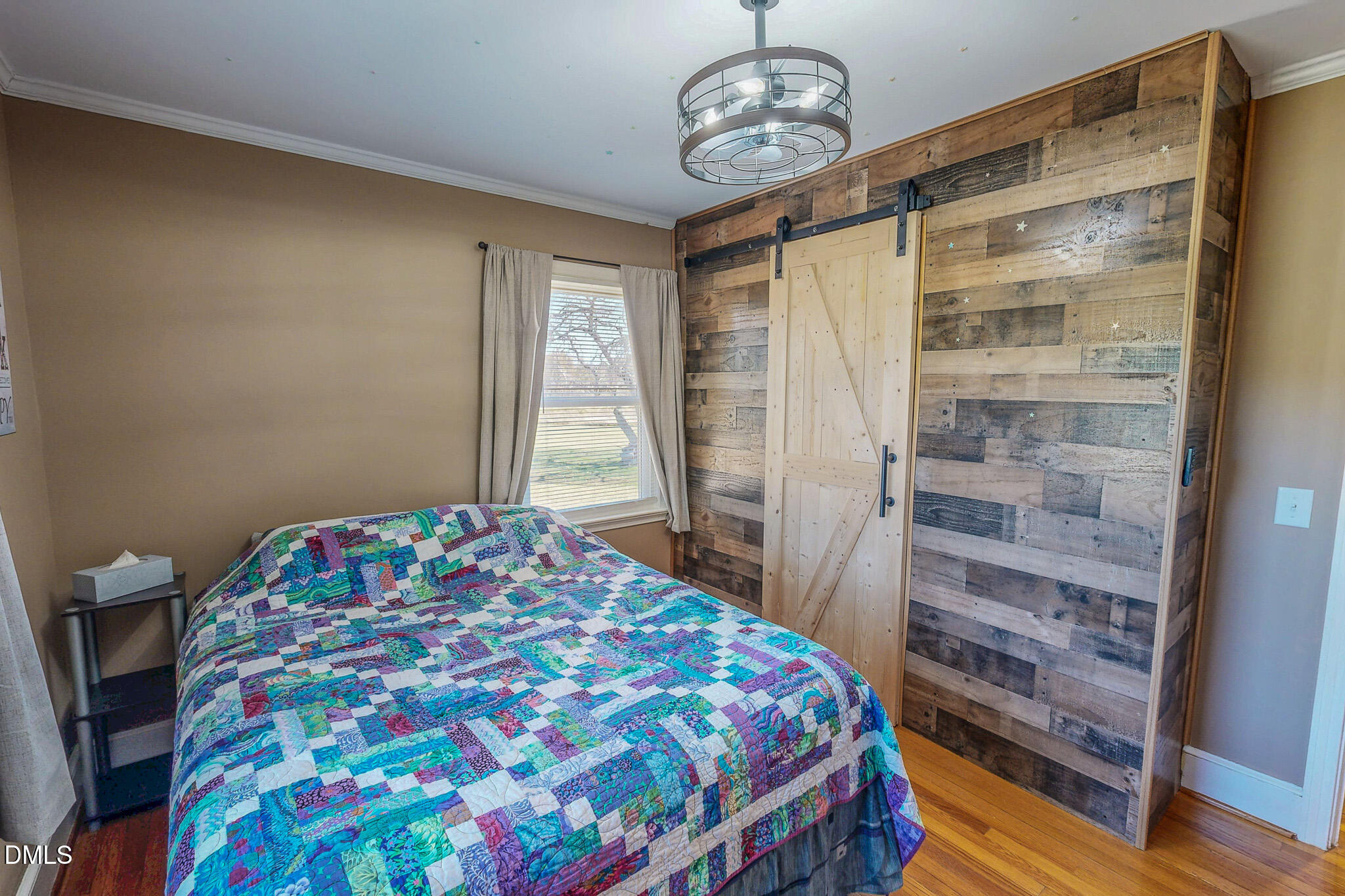 12057 Hurdle Mills Road Hurdle Mills, NC 27541 - Photo 41 of 52 a bedroom with a bed and wooden floor