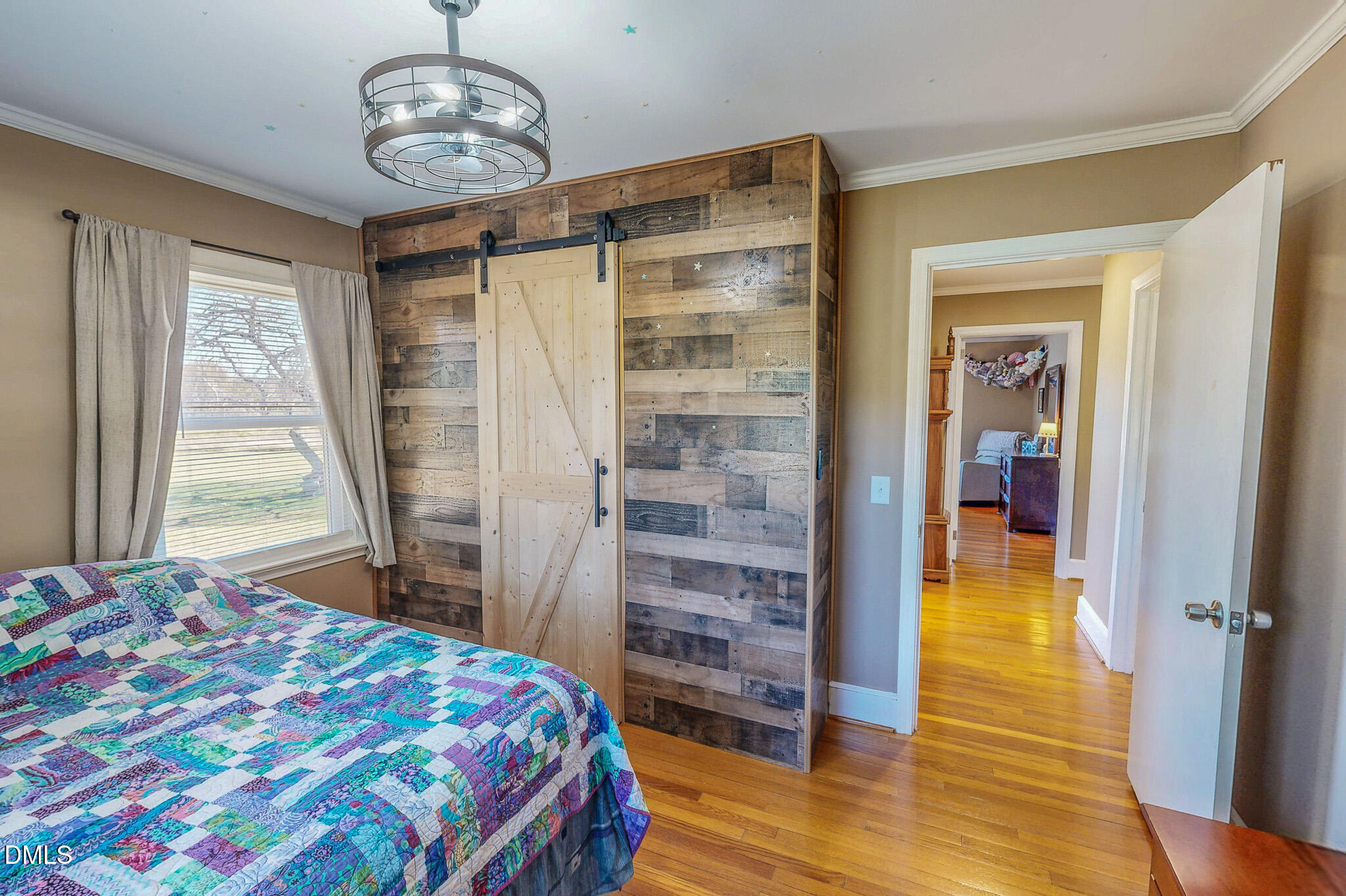 12057 Hurdle Mills Road Hurdle Mills, NC 27541 - Photo 42 of 52 a bedroom with a bed and wooden floor