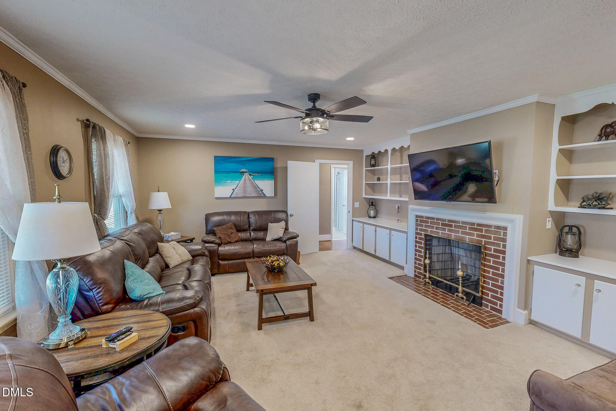 12057 Hurdle Mills Road Hurdle Mills, NC 27541 - Photo 10 of 52 a living room with fireplace furniture and a flat screen tv