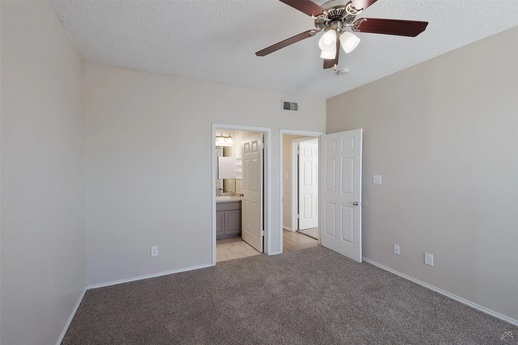 11908 Anderson Mill Road, Unit 321 Cedar Park, TX 78613 - Photo 16 of 24 an empty room with closet and a chandelier fan