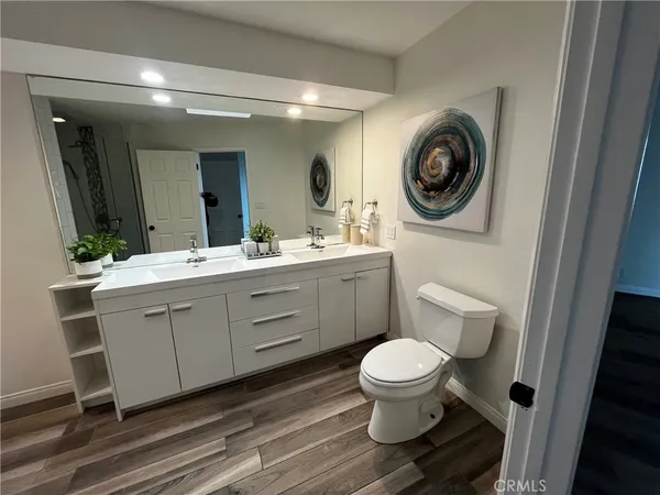 a bathroom with a toilet a sink and a mirror