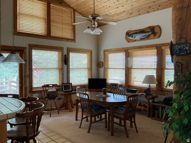 550 State Line Road Manila, UT 84046 - Photo 12 of 41 Dining area featuring wood-finish vaulted ceilings, a ceiling fan with integrated lighting, and multiple windows with wood-trimmed frames