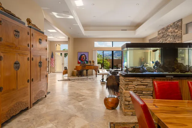 a living room with furniture a flat screen tv and a view of kitchen