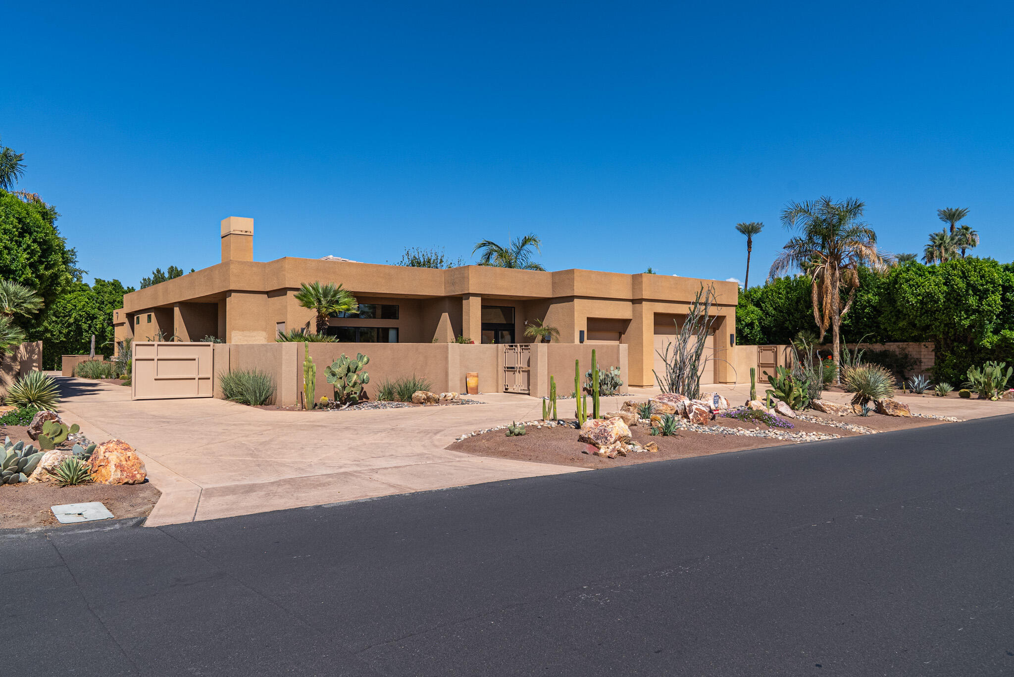 72116 Clancy Lane Rancho Mirage, CA 92270 - Photo 2 of 59 a front view of a house with a yard and garage