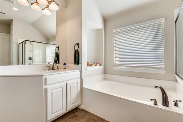 a bathroom with a bathtub a sink and a window