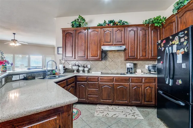 a kitchen with wooden cabinets a sink and a stove