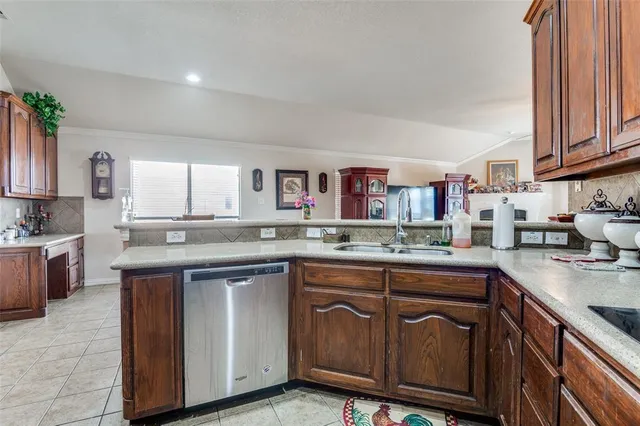 a kitchen with stainless steel appliances granite countertop a sink and cabinets