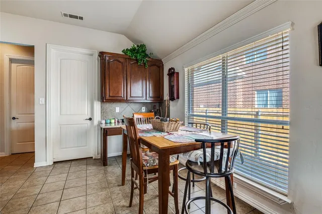 a dining room with furniture and window