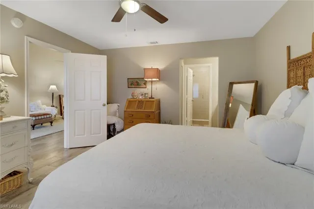 a bedroom with a bed and a large mirror