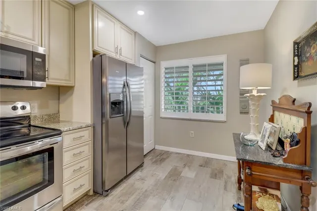 a kitchen with stainless steel appliances a refrigerator stove and microwave