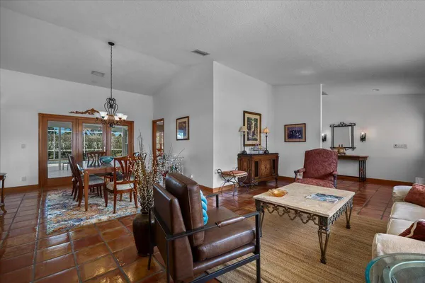 a living room with furniture a table and a potted plant