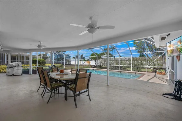 a view of a patio with table and chairs under an umbrella