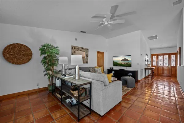 a kitchen with kitchen island granite countertop a sink chairs and cabinets