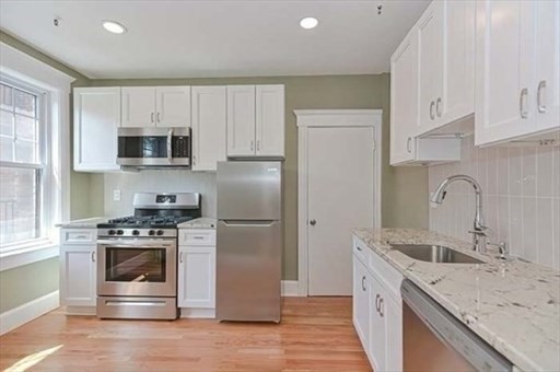 70 Strathmore Road, Unit 9B Boston, MA 02135 - Photo 4 of 19 a kitchen with a sink a stove and refrigerator