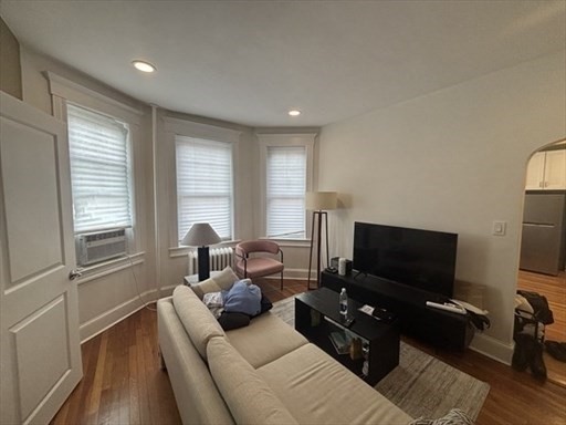 70 Strathmore Road, Unit 9B Boston, MA 02135 - Photo 7 of 19 a living room with furniture and a flat screen tv