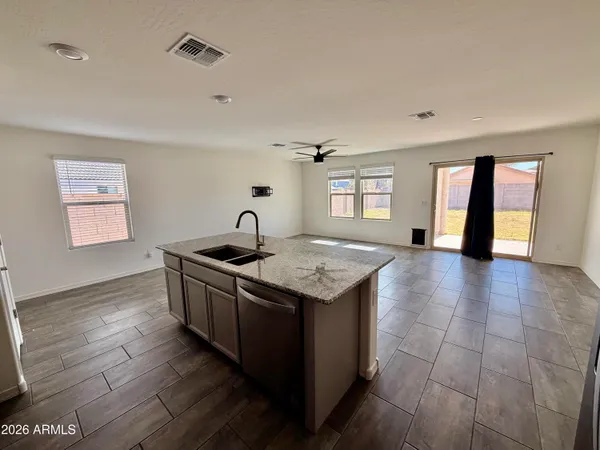 a kitchen with granite countertop a sink and a stove