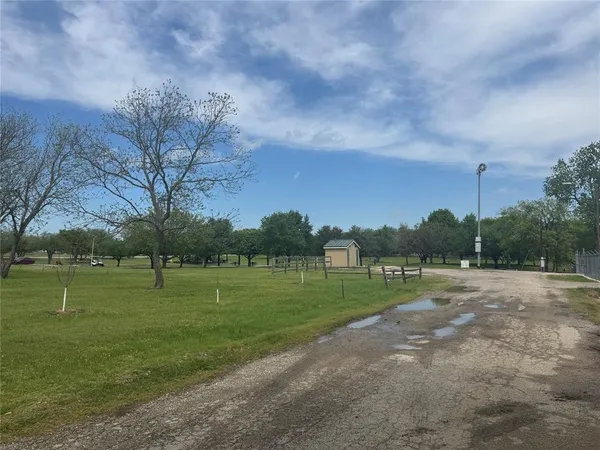 a view of outdoor space with green field and trees