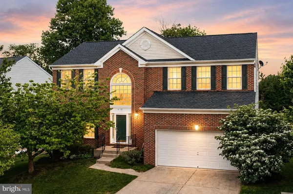 a front view of a house with a yard garage and outdoor seating