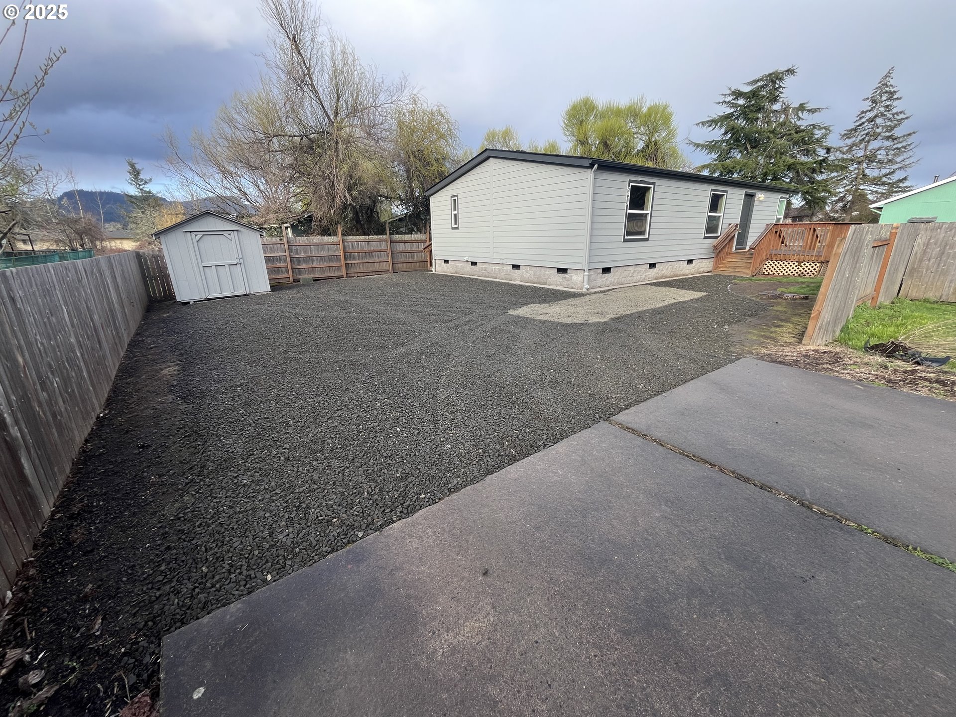 7032 Main Street Springfield, OR 97478 - Photo 1 of 17 a view of a white house with a yard