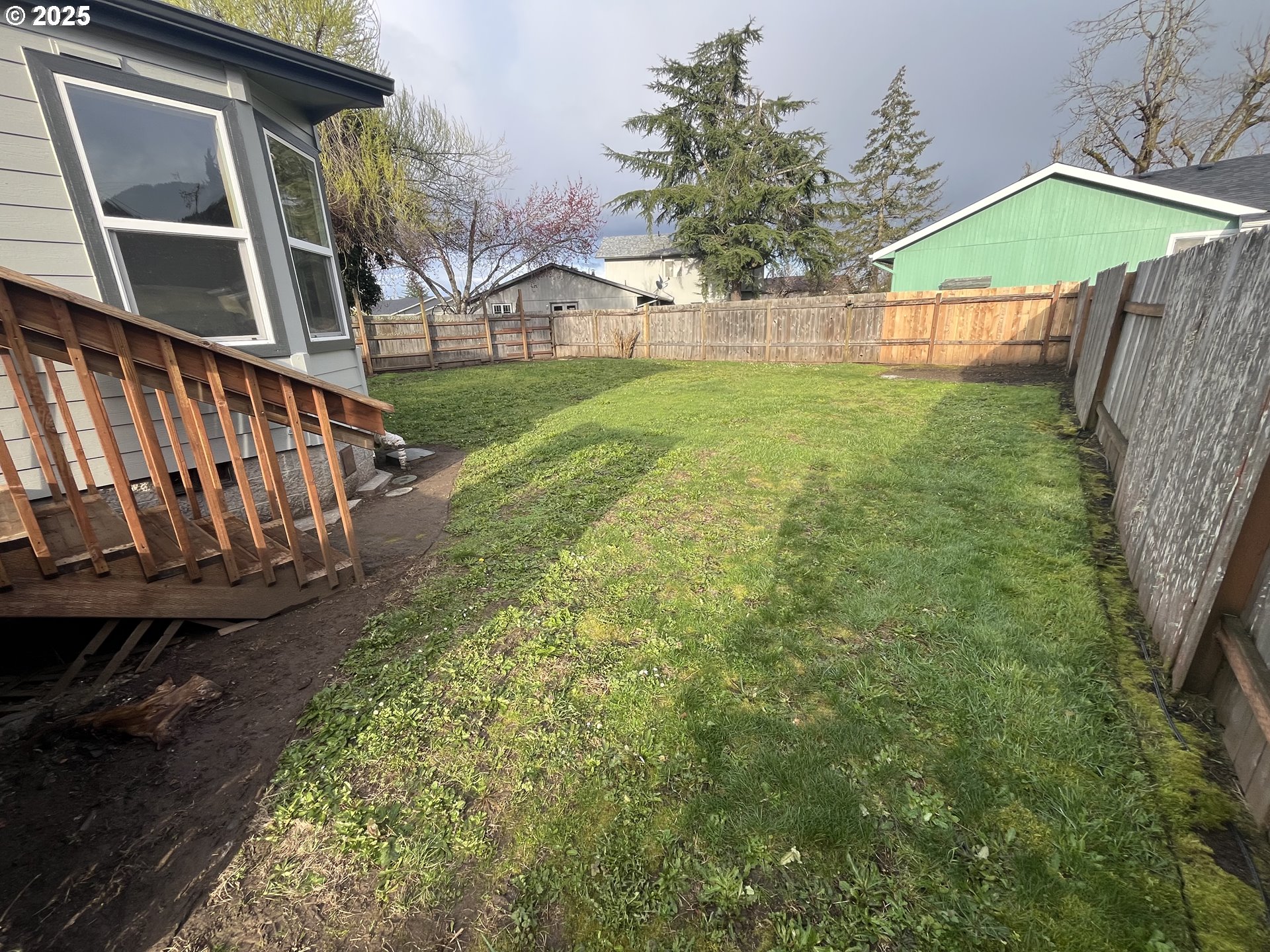 7032 Main Street Springfield, OR 97478 - Photo 6 of 17 a view of an house with backyard and trees
