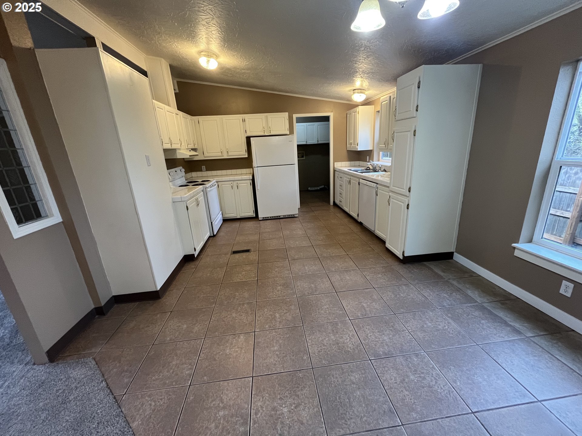 7032 Main Street Springfield, OR 97478 - Photo 9 of 17 a kitchen with refrigerator and cabinets