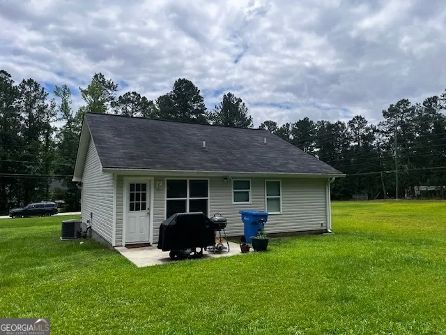 a view of a house with backyard porch and garden