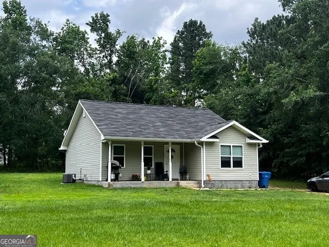 a front view of a house with a garden and porch