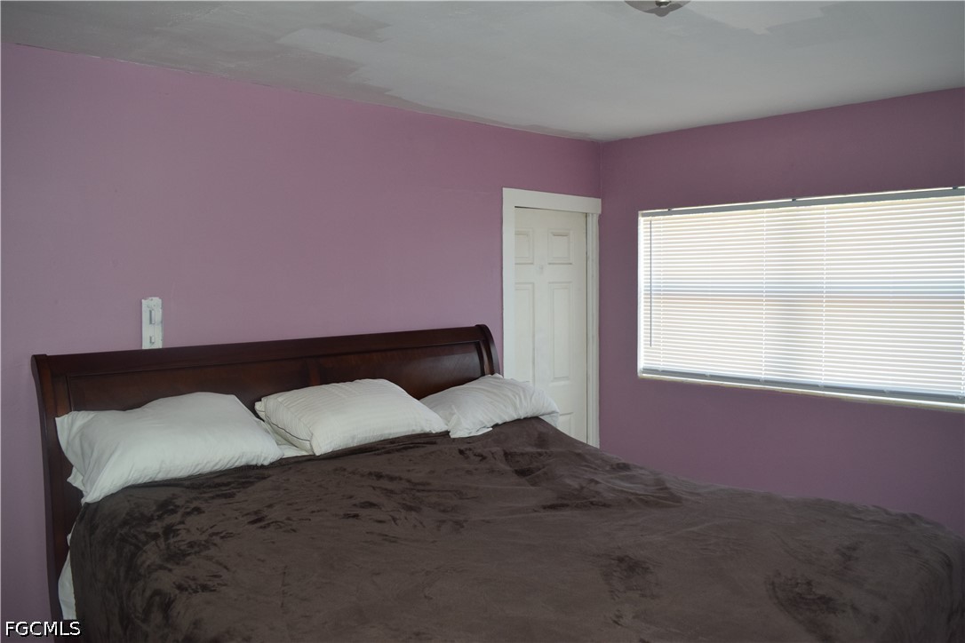 17 Colorado Road Lehigh Acres, FL 33936 - Photo 12 of 17 a bedroom with a bed and a window
