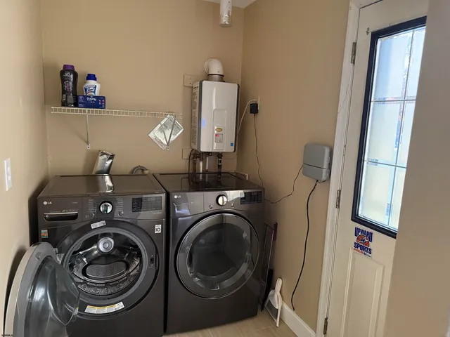 a utility room with sink dryer and washer