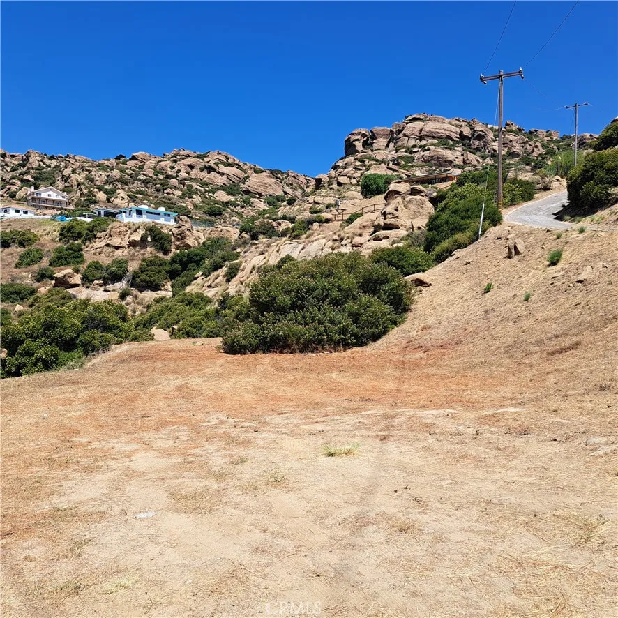 0 Thompson Chatsworth, CA 91311 - Photo 2 of 12 a view of a dry yard with a wooden wall