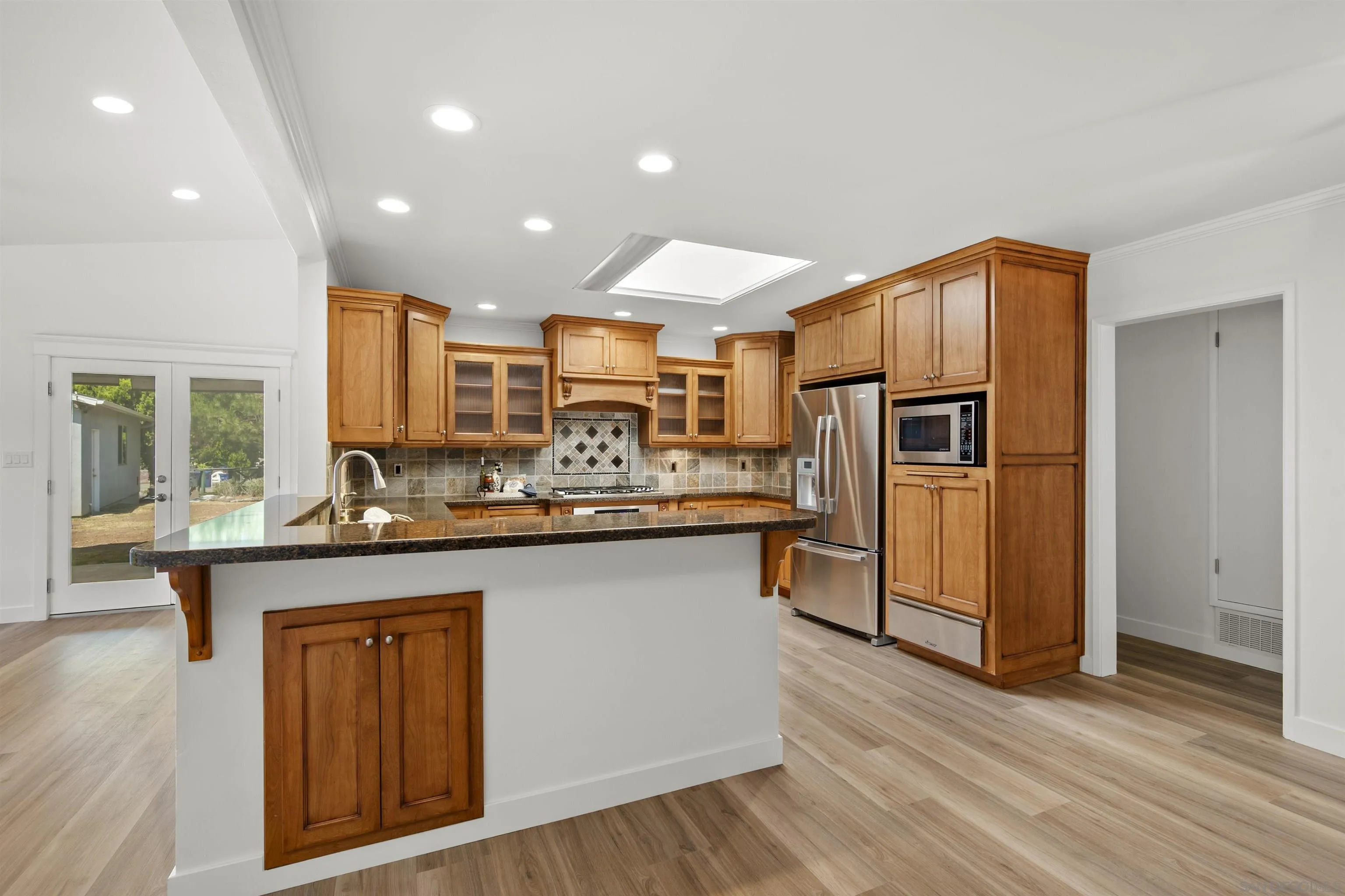 1835 Westward Ho Circle El Cajon, CA 92021 - Photo 17 of 57 a kitchen with stainless steel appliances granite countertop a sink and refrigerator