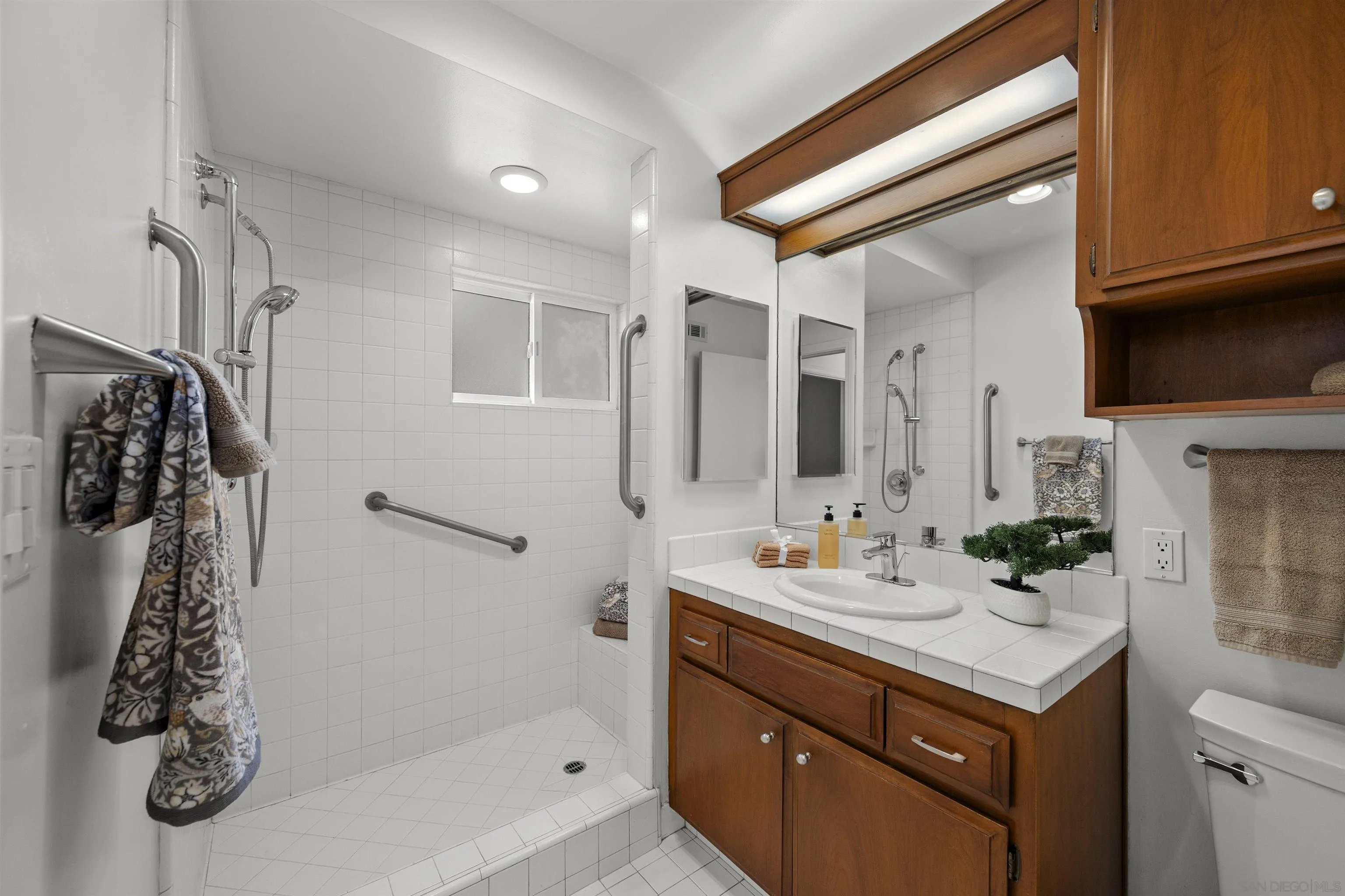 1835 Westward Ho Circle El Cajon, CA 92021 - Photo 37 of 57 a bathroom with a sink a mirror and shower