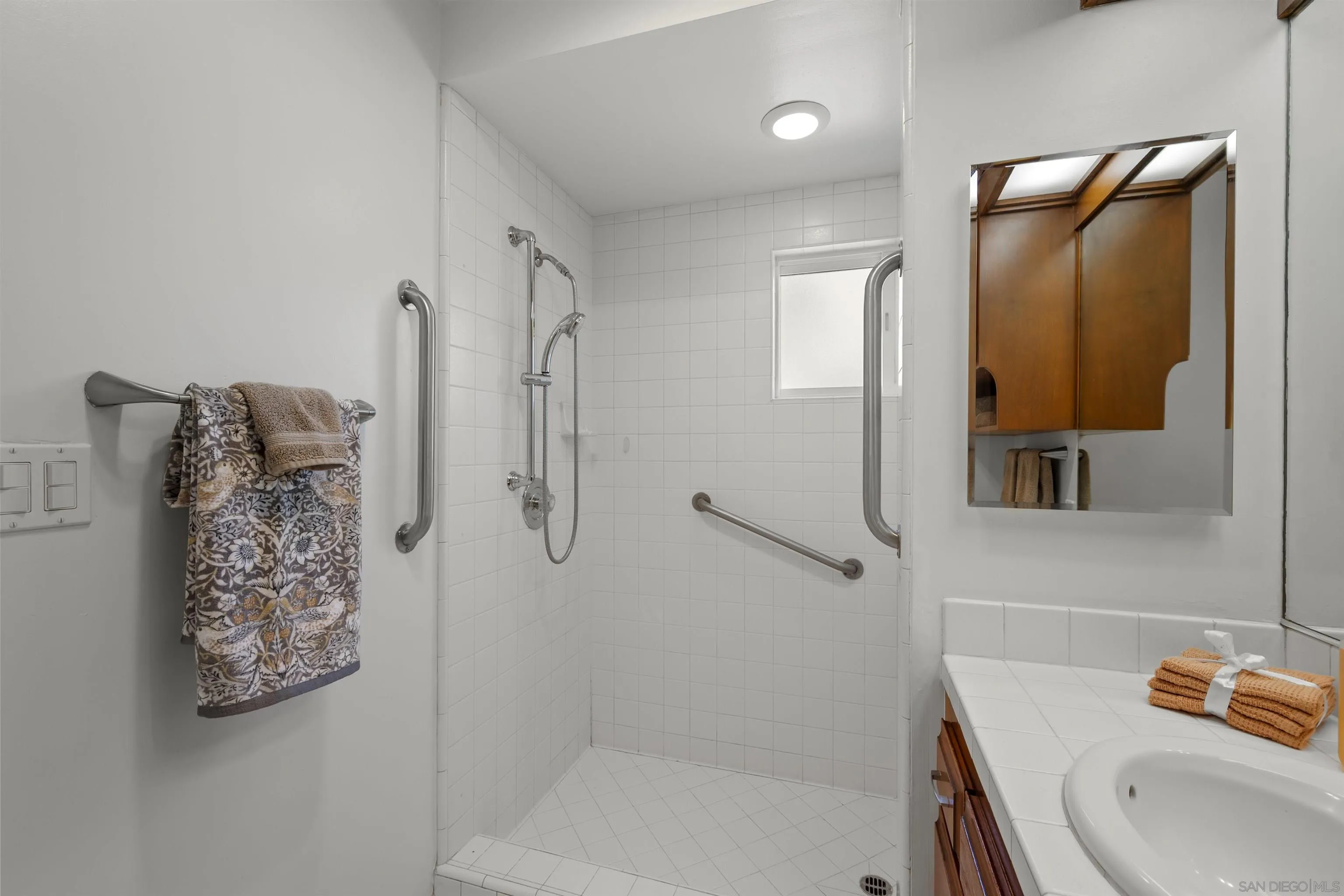 1835 Westward Ho Circle El Cajon, CA 92021 - Photo 38 of 57 a bathroom with a shower sink and mirror