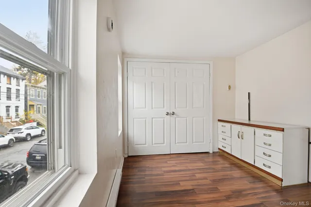 a view of a hallway with wooden floor windows and entryway