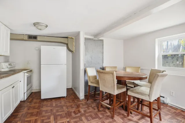 a dining room with furniture and window