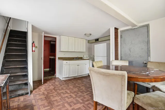 a living room with stainless steel appliances kitchen island granite countertop furniture and a kitchen view