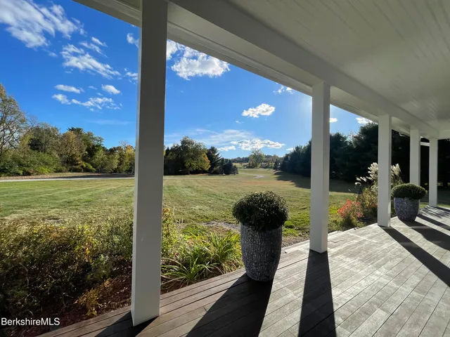 a view of empty room with a window and wooden floor