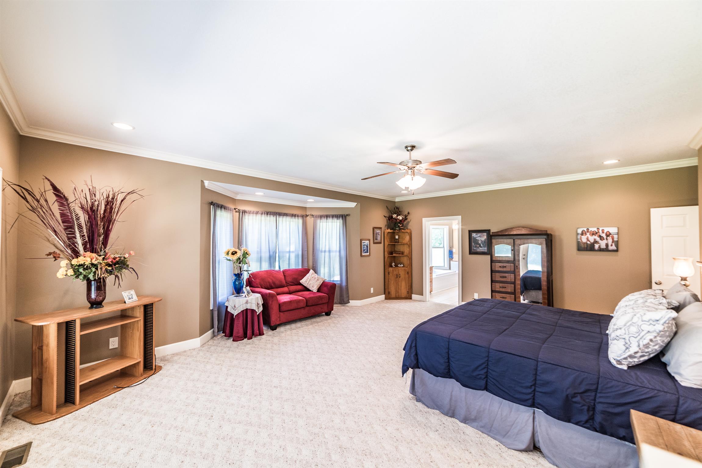 41 Pepper Road Taft, TN 38488 - Photo 14 of 30 a spacious bedroom with a large bed and a chandelier