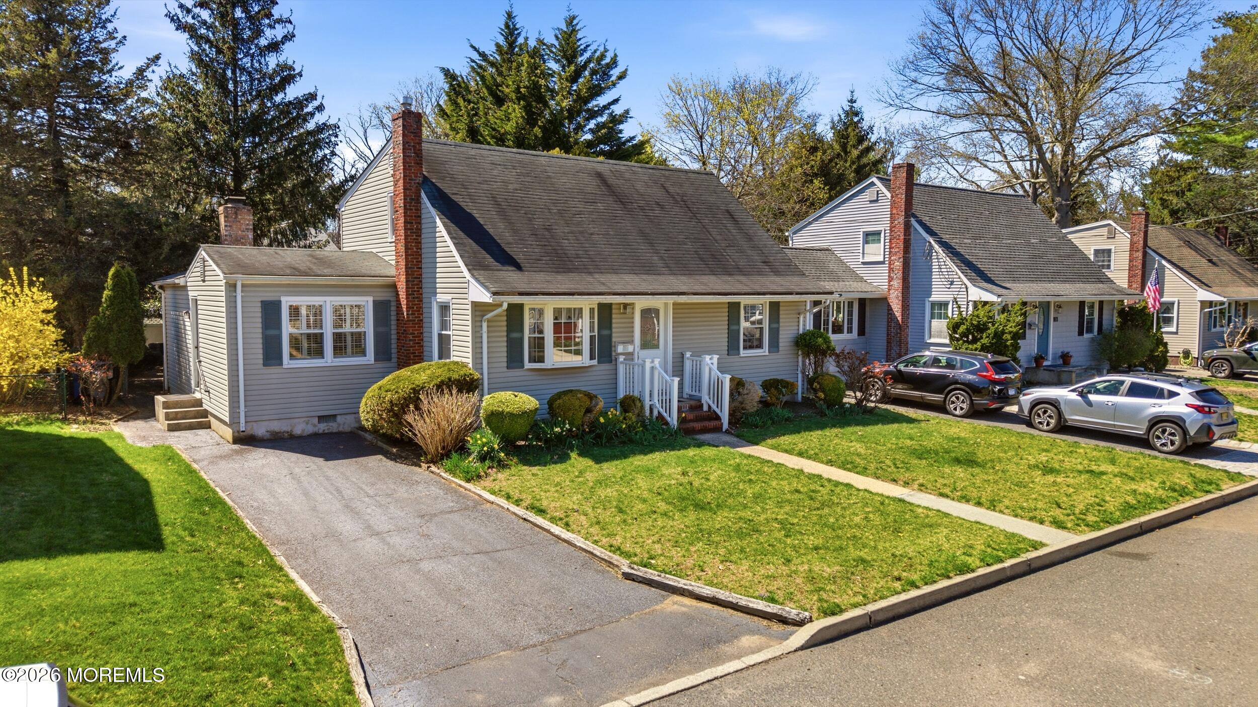 68 Davis Lane Red Bank, NJ 07701 - Photo 2 of 41 a view of a white house next to a yard with big trees