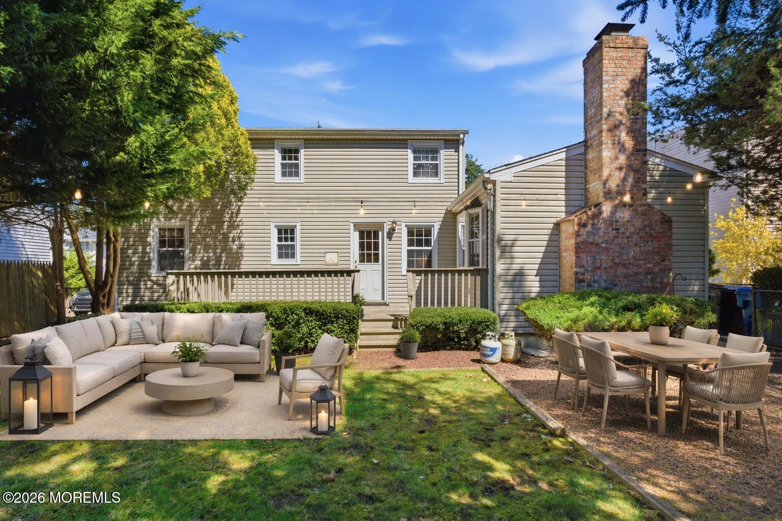 68 Davis Lane Red Bank, NJ 07701 - Photo 28 of 41 a view of a patio with couches table and chairs and potted plants
