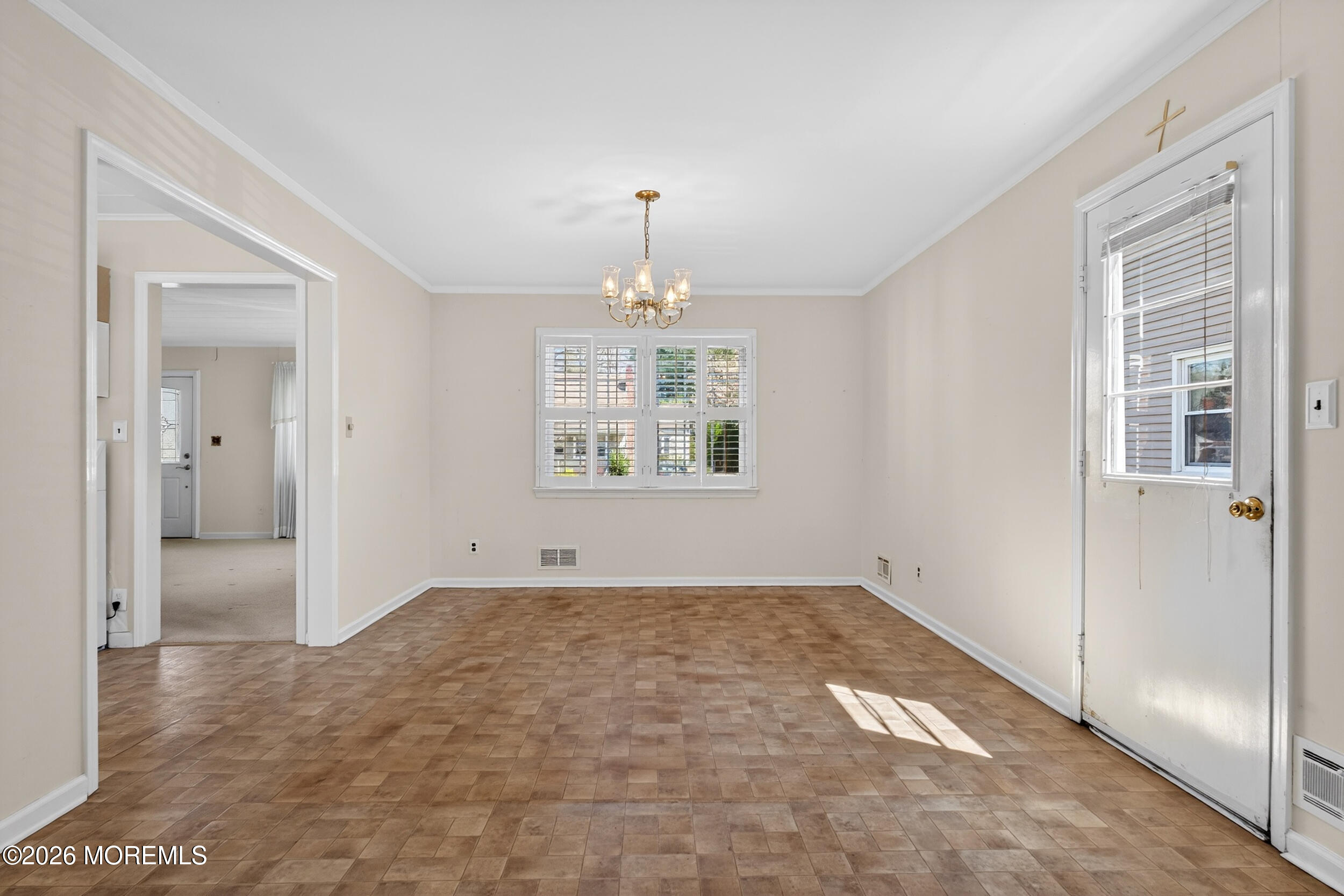 68 Davis Lane Red Bank, NJ 07701 - Photo 8 of 41 an empty room with chandelier fan and windows