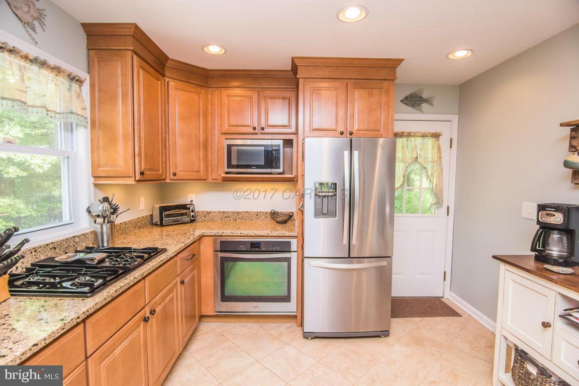56 Pinehurst Road Ocean Pines, MD 21811 - Photo 14 of 42 a kitchen with stainless steel appliances granite countertop a refrigerator stove and sink