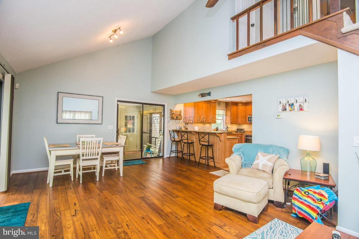 56 Pinehurst Road Ocean Pines, MD 21811 - Photo 22 of 42 a living room with furniture and a dining table with wooden floor