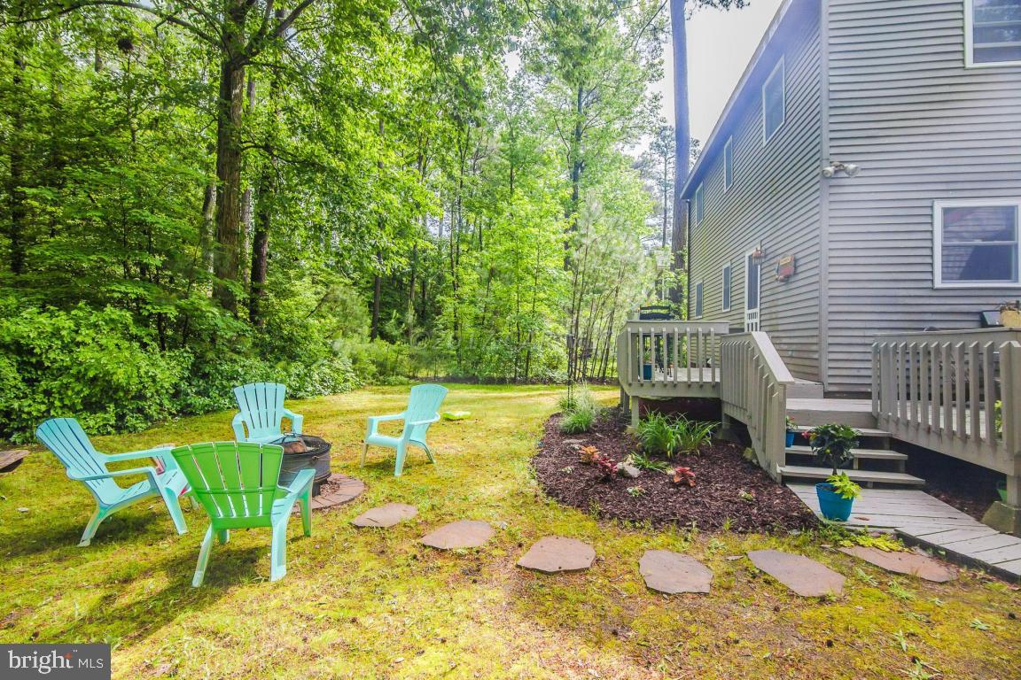 56 Pinehurst Road Ocean Pines, MD 21811 - Photo 7 of 42 a view of an chairs and tables in the backyard
