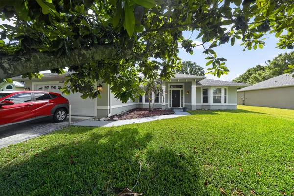 a front view of a house with a garden