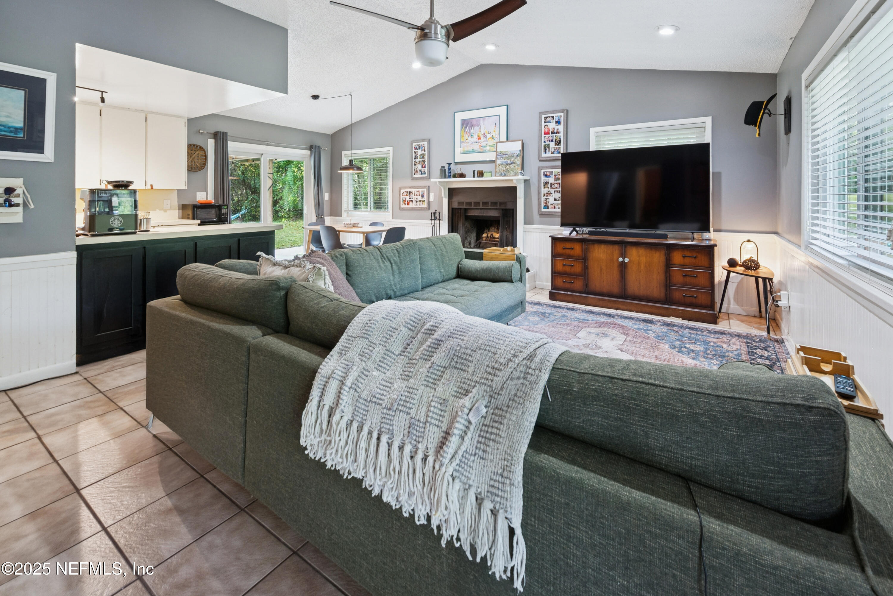 18311 Northeast 21 Street Gainesville, FL 32609 - Photo 14 of 80 a living room with furniture and a flat screen tv