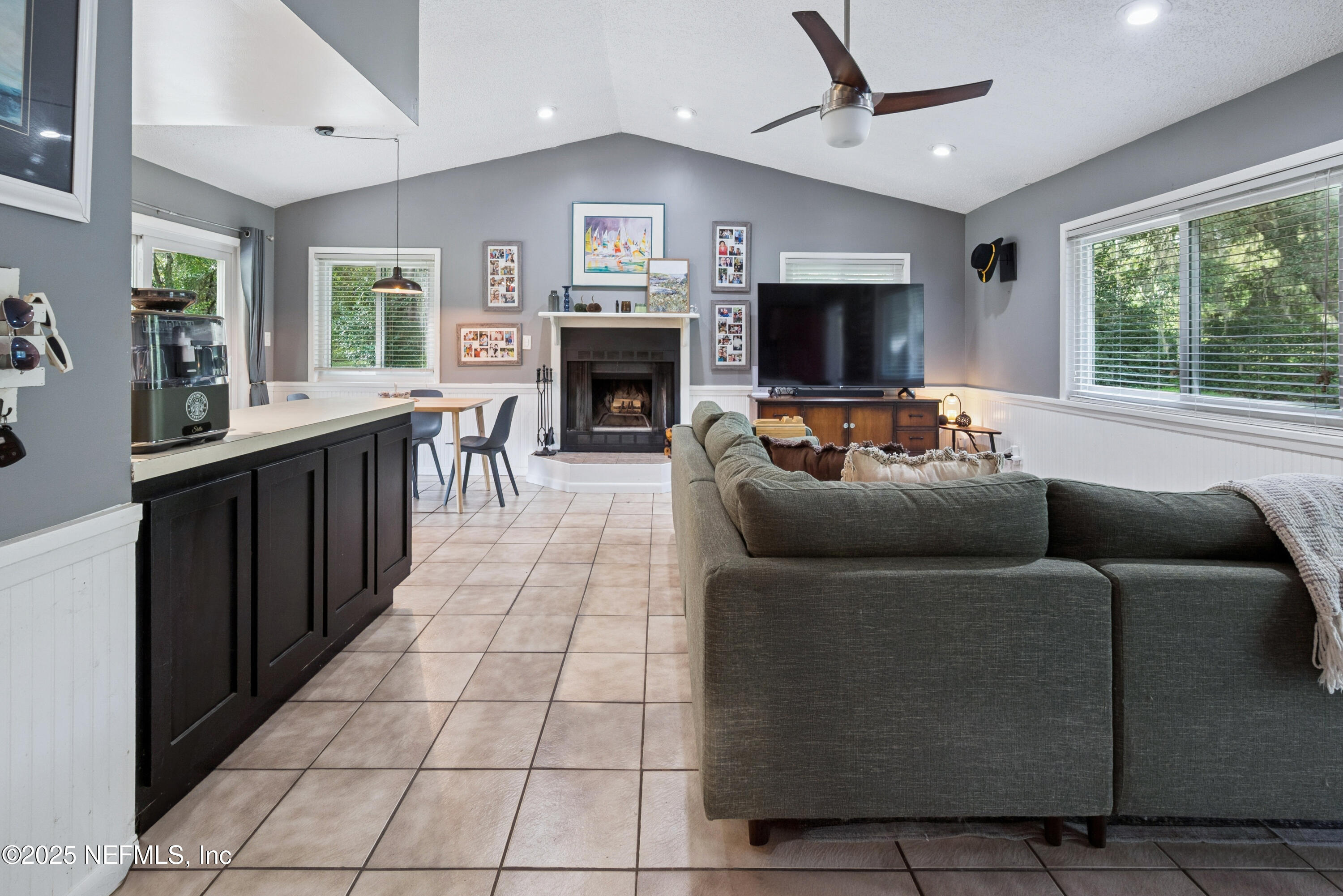18311 Northeast 21 Street Gainesville, FL 32609 - Photo 15 of 80 a living room with furniture and a flat screen tv